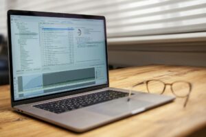 Laptop screen displaying social media analytics dashboard with charts and performance metrics