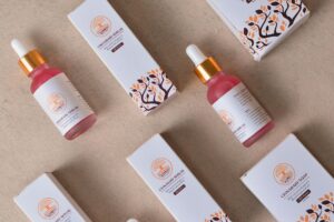 Designer working on product packaging layout with sketches and color samples