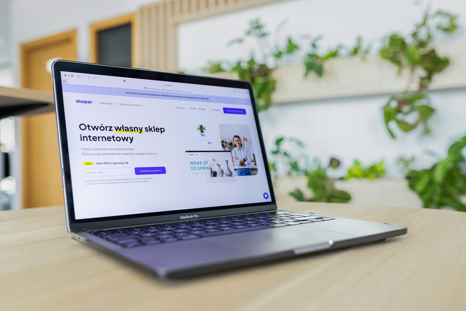 Person using laptop for online pet supply shopping with dog nearby