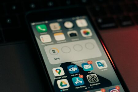 Person holding smartphone showing new message notification on screen