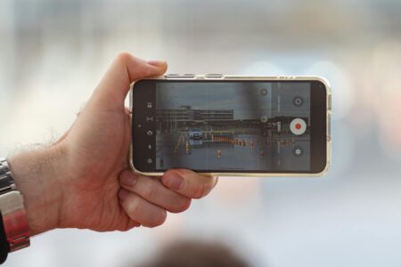 Person filming content with smartphone for social media