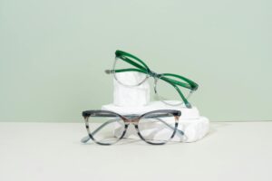 Multiple eyeglass frames displayed on a clean surface showing variety of styles
