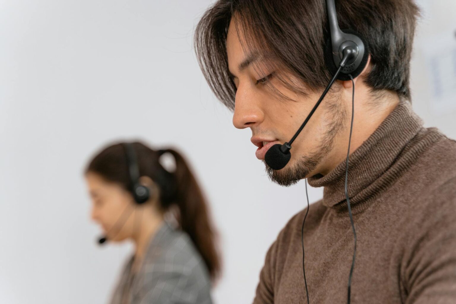 How to Turn Customer Support Conversations into Viral Content Customer service representative wearing headset while working at computer desk
