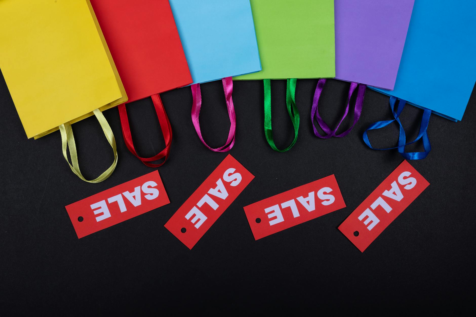 Shopping bags on wooden surface representing consumer retail purchases