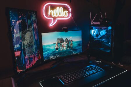Gaming setup with multiple monitors displaying colorful game interfaces and community features