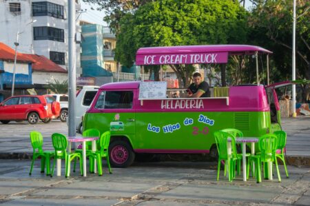 Colorful food truck parked on urban street serving customers