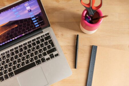 Clean laptop workspace showing email marketing dashboard on screen