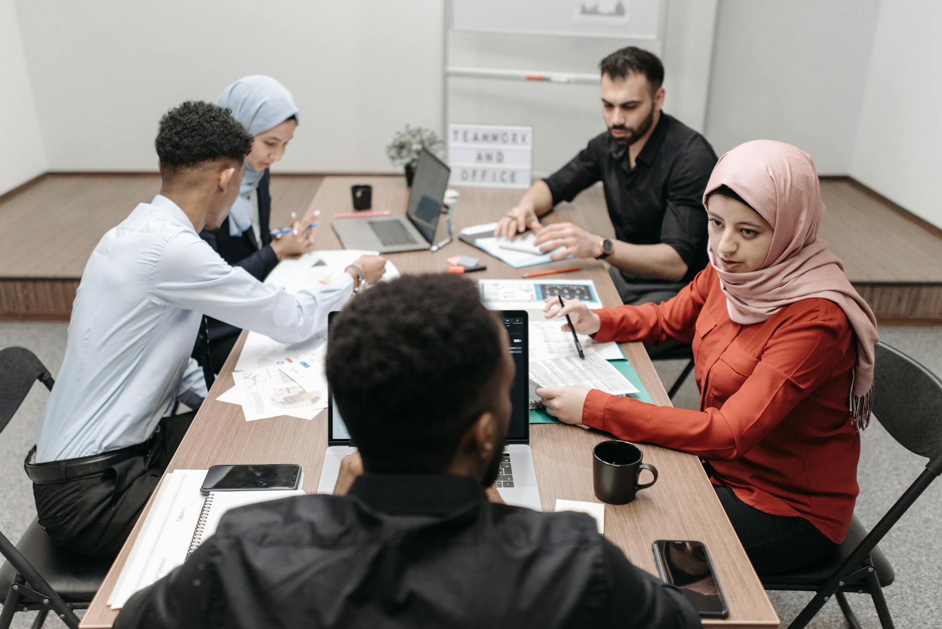 Business team discussing strategy around conference table