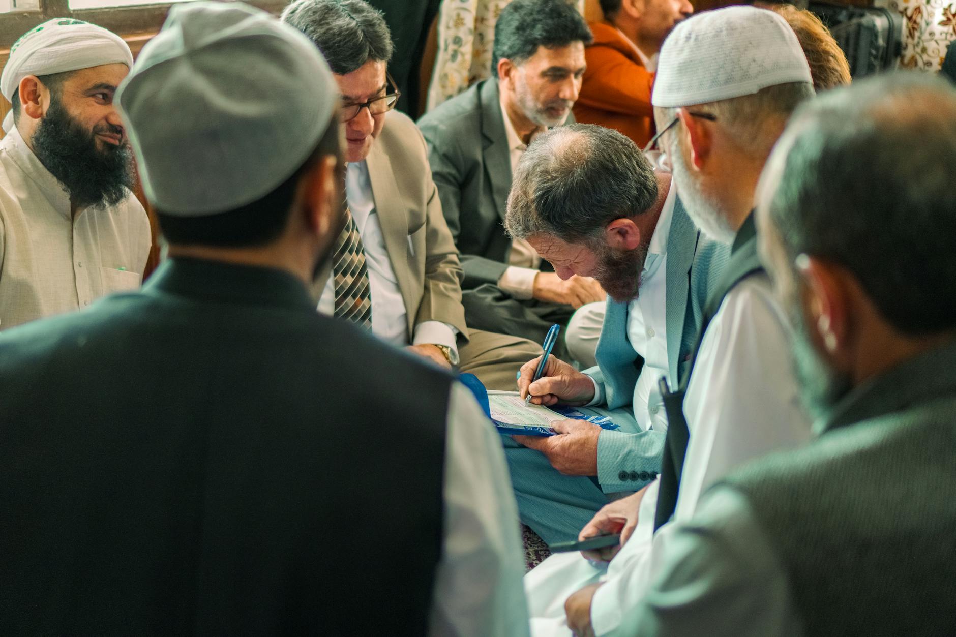 Small group of people engaged in animated discussion around a table