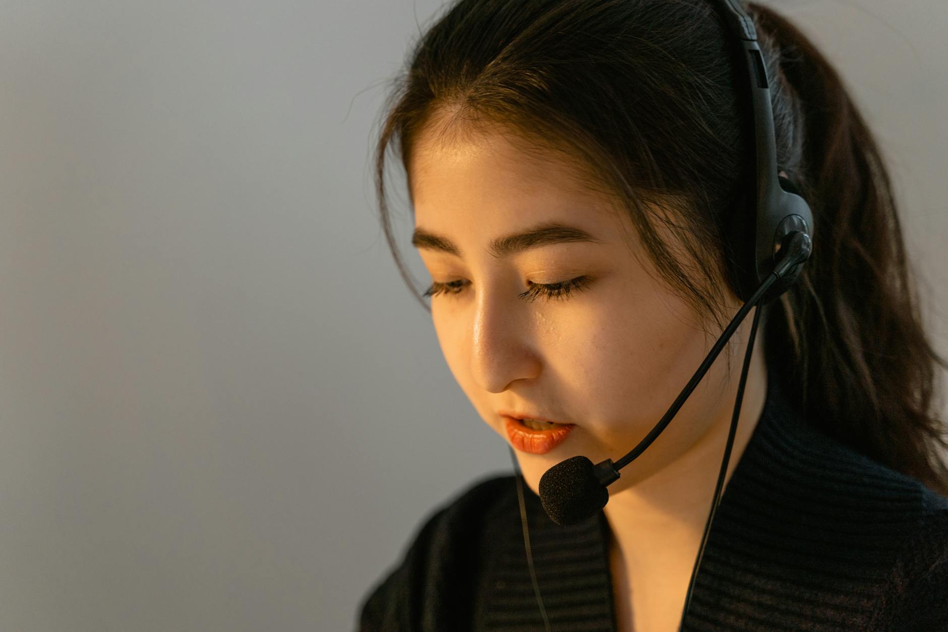 Professional customer service representative wearing headset at computer desk