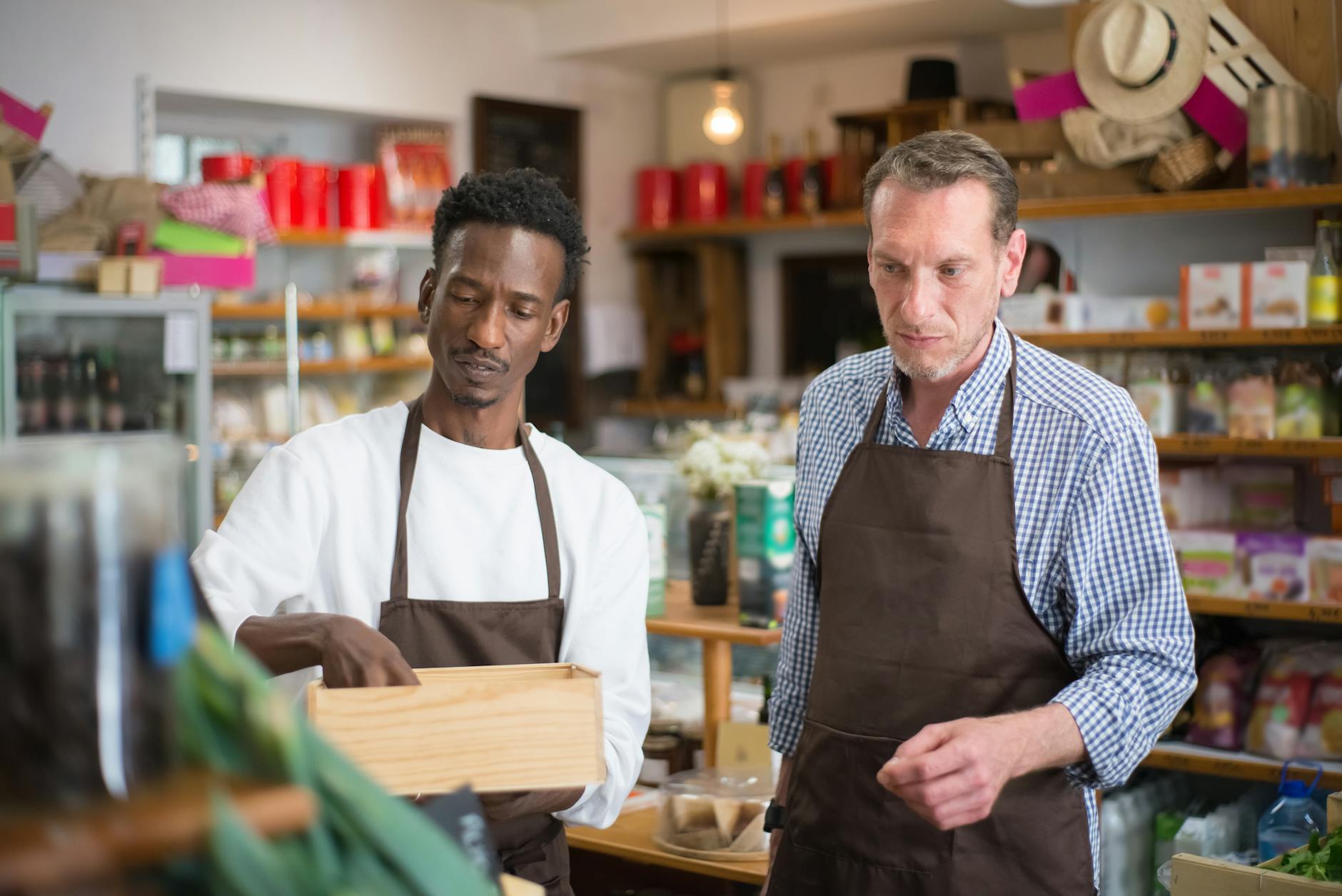 Small business owner working behind counter in shop
