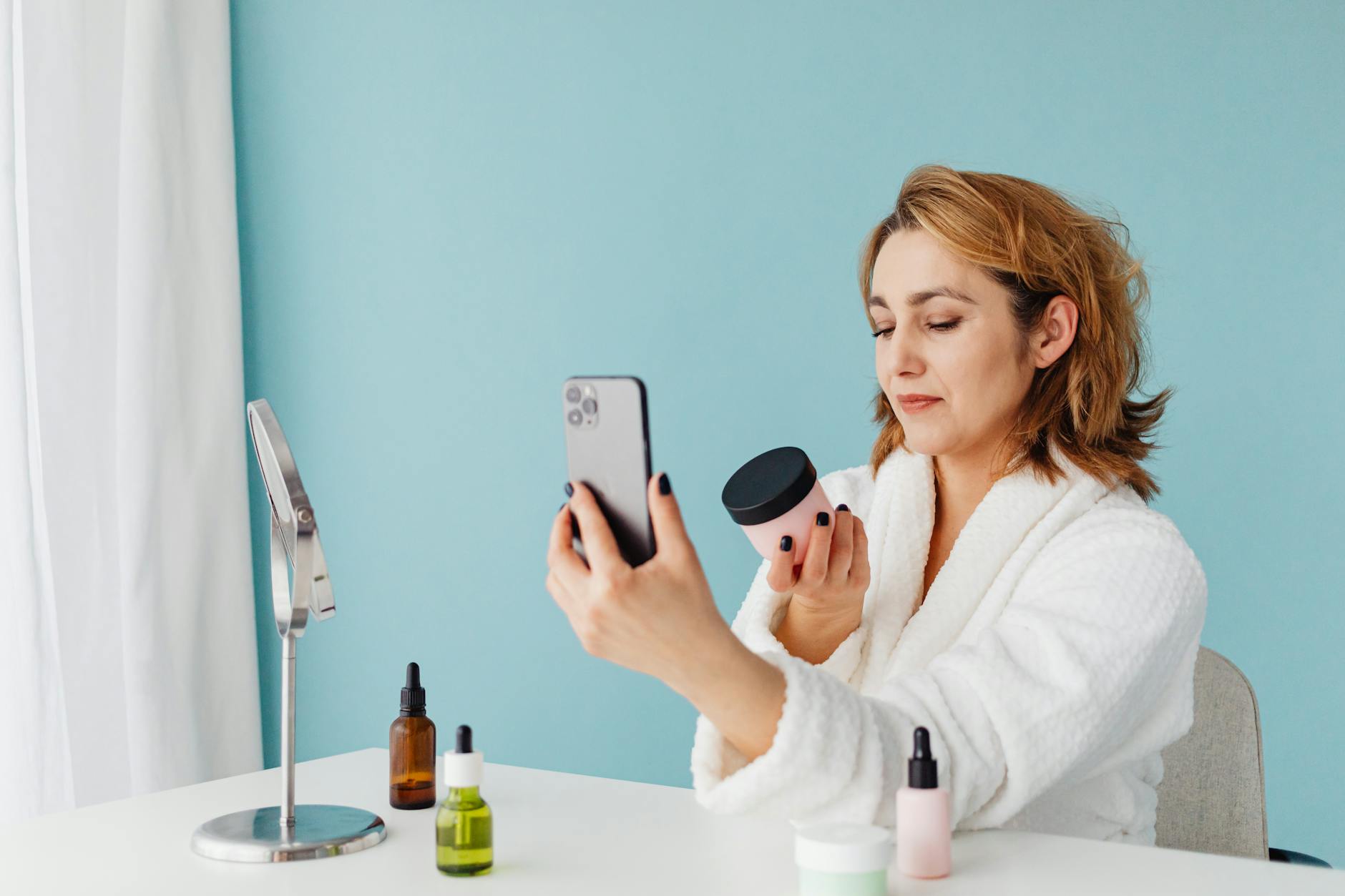 Woman taking a mirror selfie while trying on eyeglasses in natural lighting