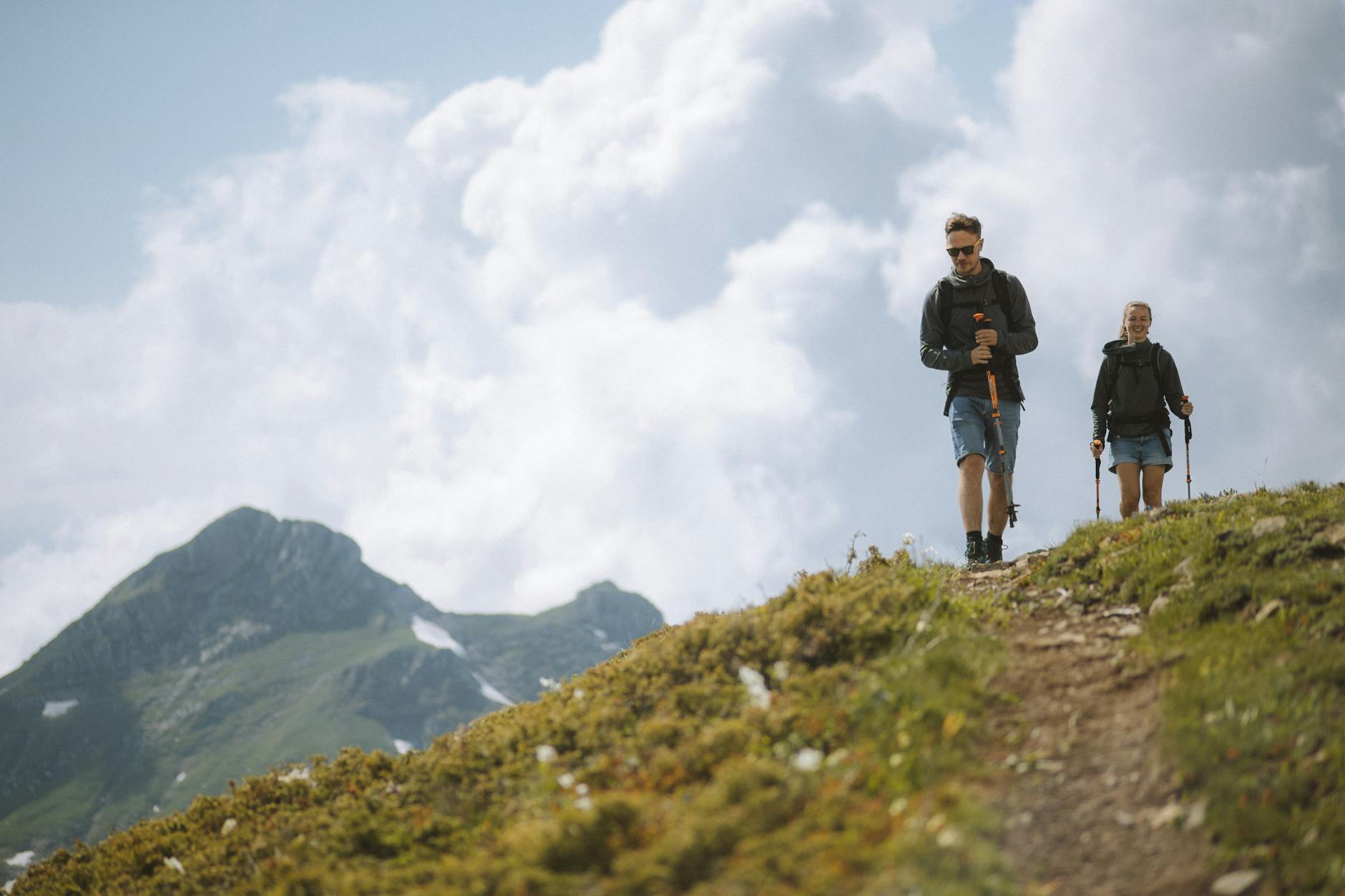 Person hiking on mountain trail wearing outdoor gear