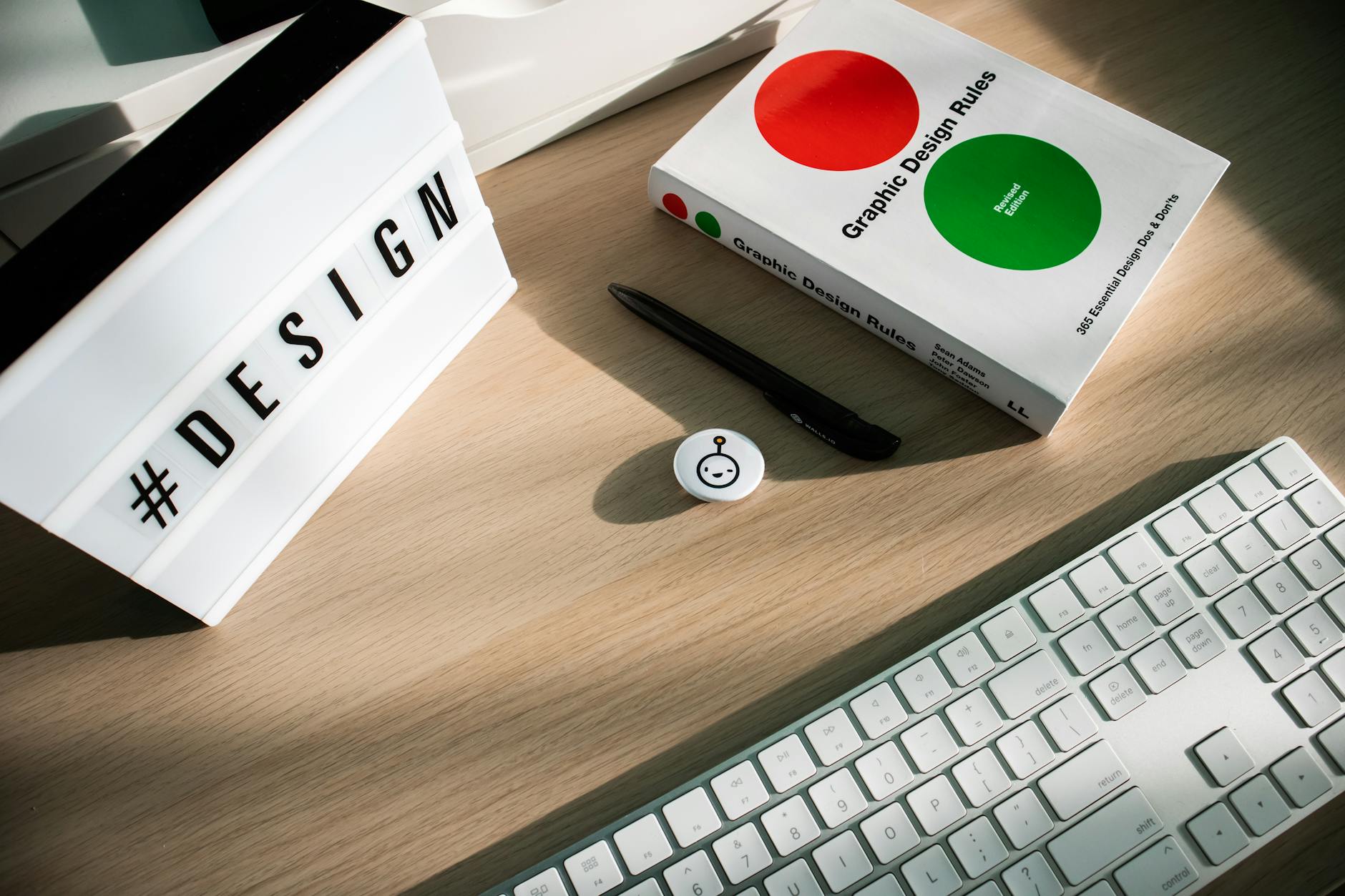 Clean desk workspace with laptop, design tools, and color swatches for creative work