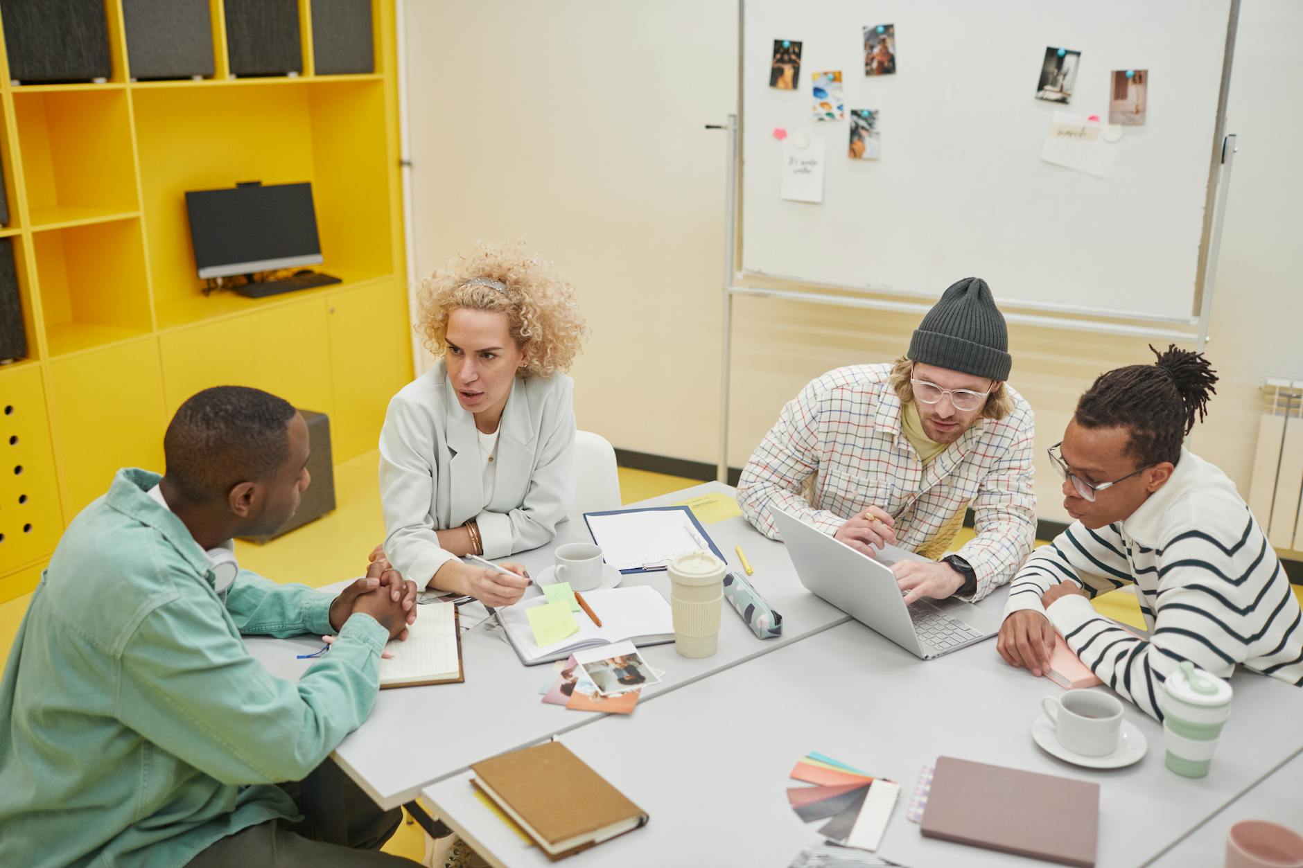 Business team collaborating around a table with notebooks and laptops for content strategy
