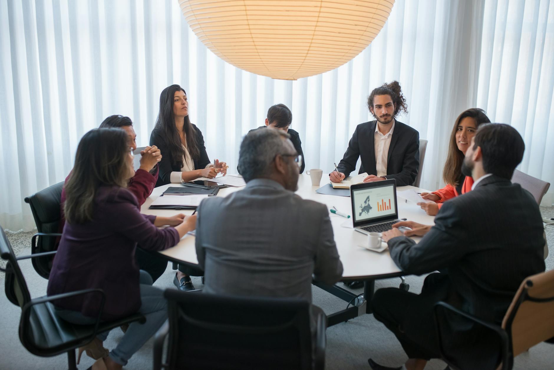 Business team collaborating around a conference table discussing digital strategy
