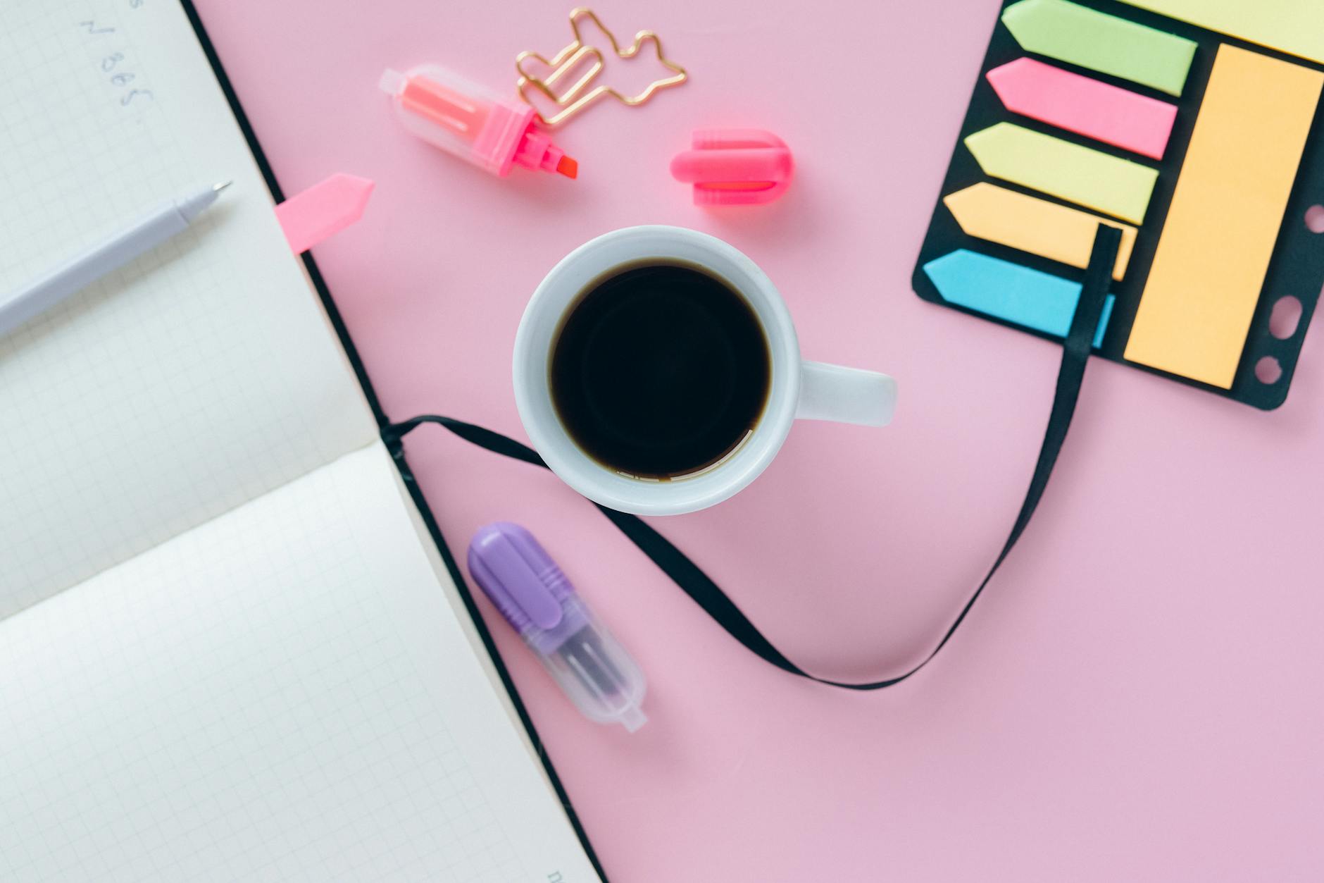 Laptop and coffee cup on desk representing targeted morning playlist advertising