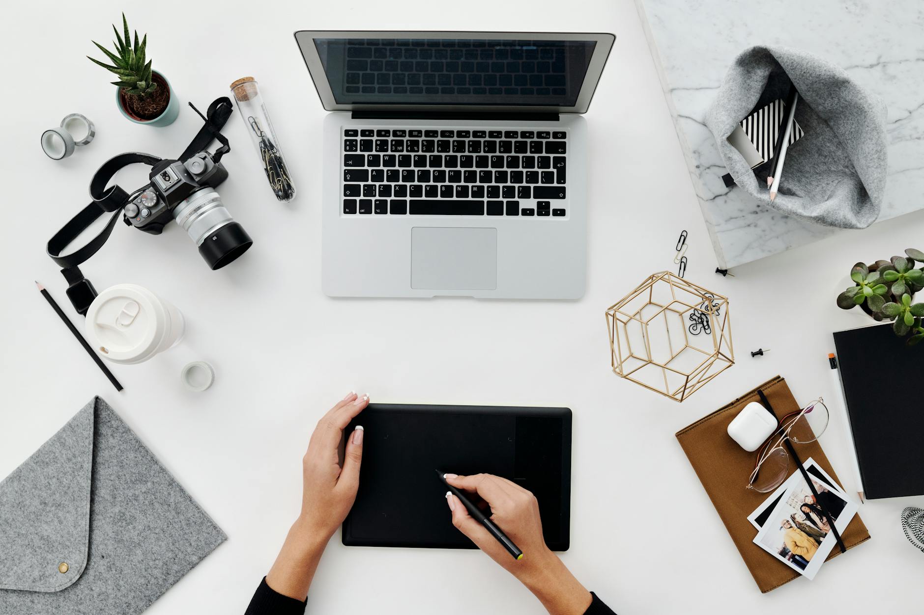 Modern workspace with laptop, coffee, and creative materials for content planning