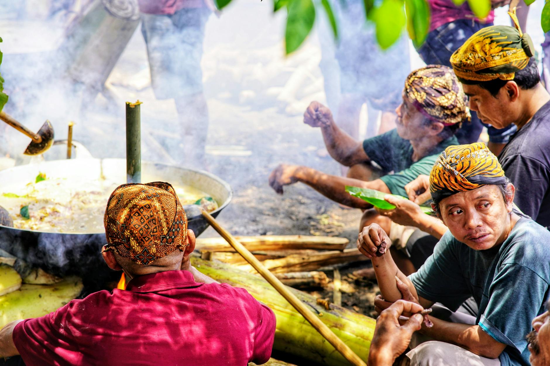 Group of people sharing a meal together around a dining table in a warm, social setting