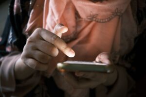Young person scrolling through a social media feed on a smartphone