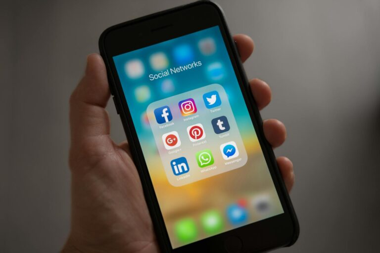 Person scrolling LinkedIn feed on a mobile device showing sponsored content