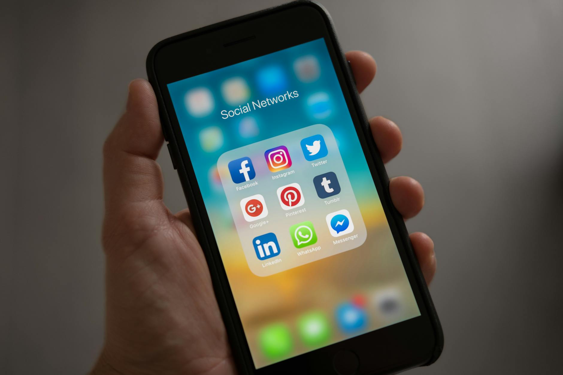 Person scrolling LinkedIn feed on a mobile device showing sponsored content