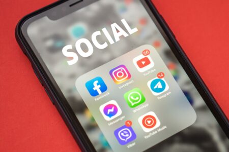 Person scrolling through social media content on a smartphone