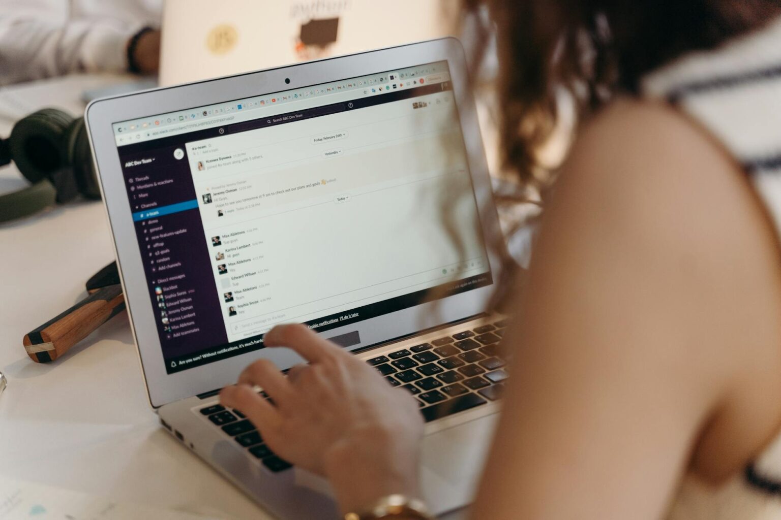 Person reading newsletter on laptop screen with messaging interface visible