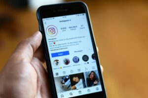 Smartphone displaying Instagram Stories interface with colorful story highlights