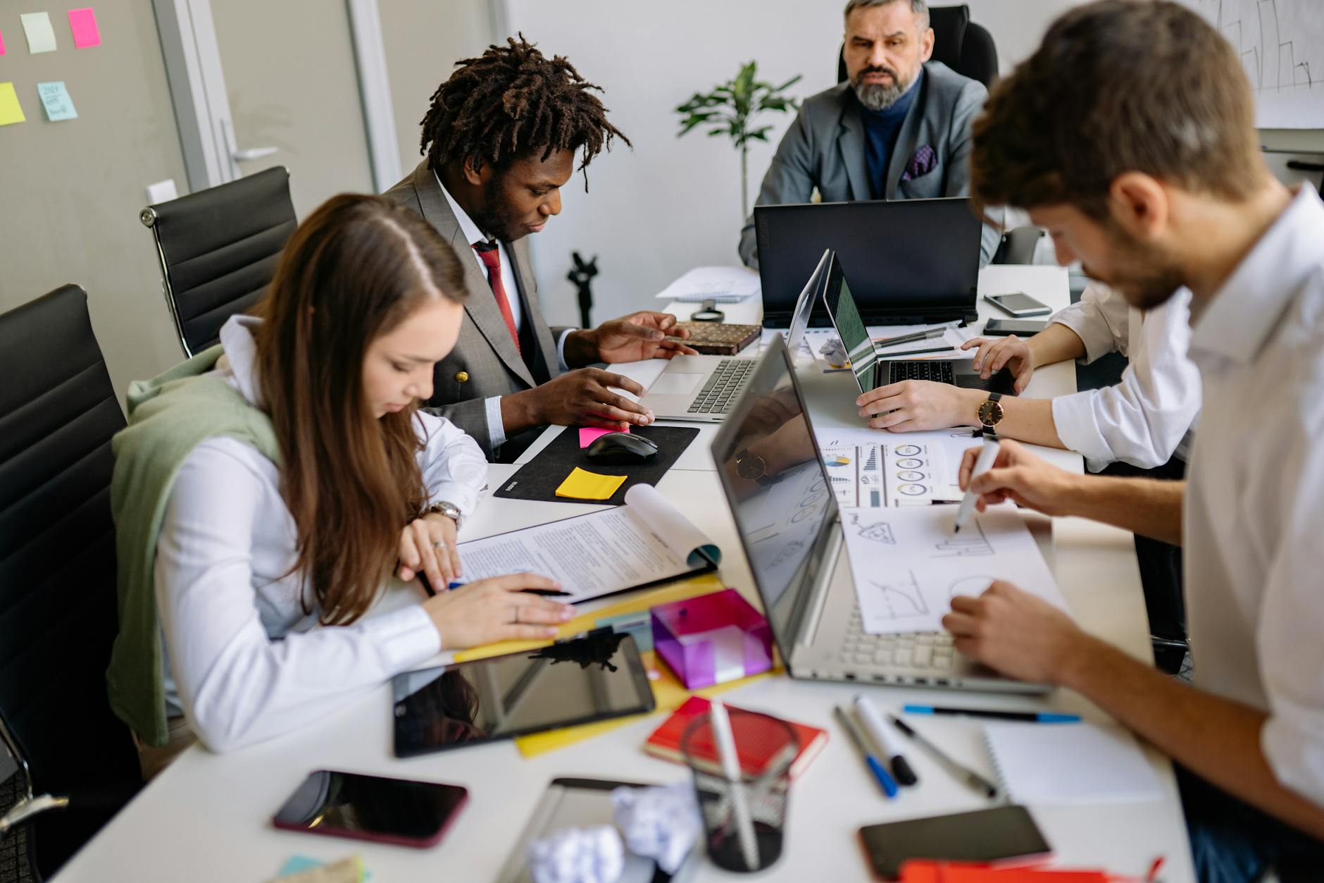 Marketing team reviewing content strategy on laptops in a modern office setting