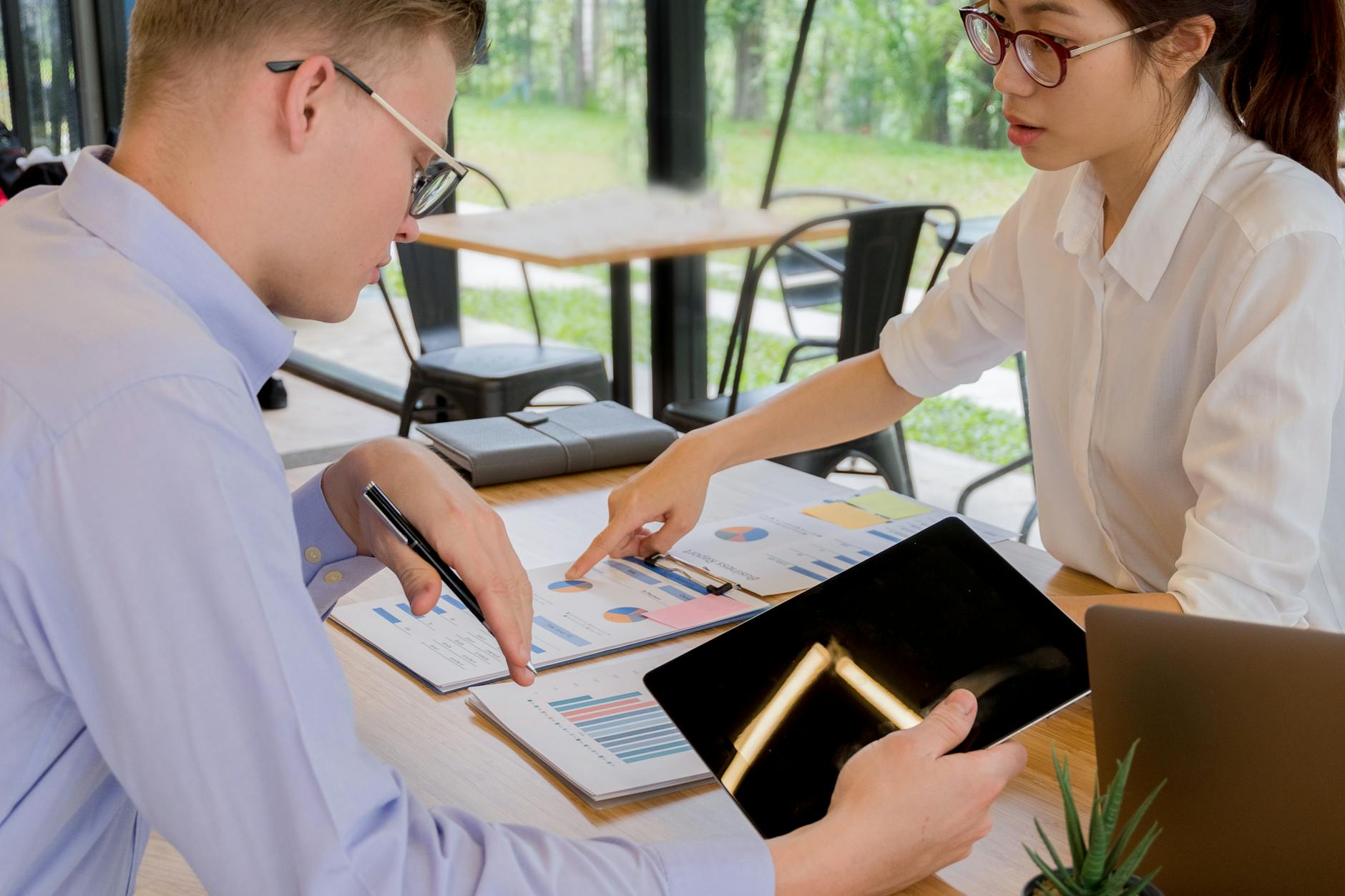 B2B professionals in a meeting reviewing content strategy on a laptop