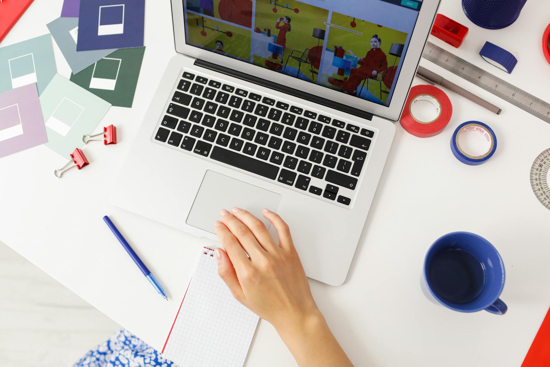 Creative workspace with laptop displaying digital design interface