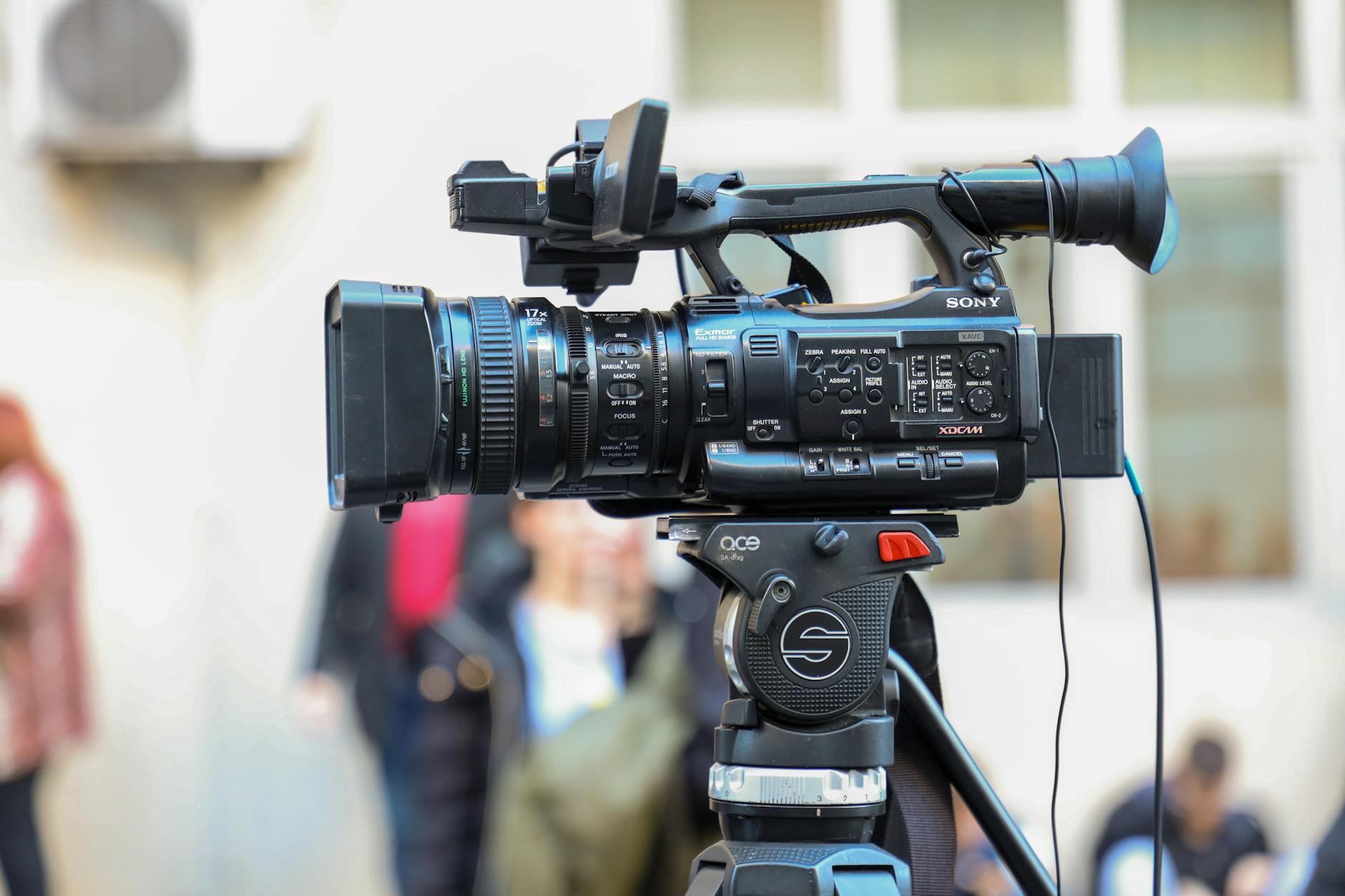 A business professional recording a short video on a smartphone in an office environment