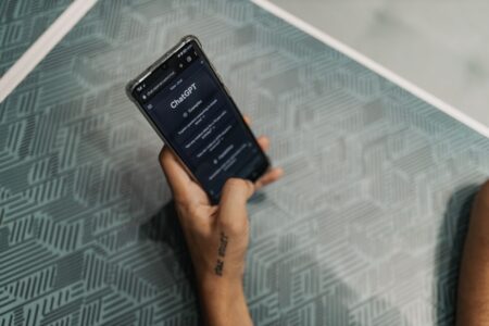 Person scrolling through a chat interface on a smartphone, representing AI messaging on social platforms