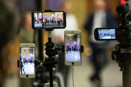 Person holding smartphone watching a live video broadcast on social media