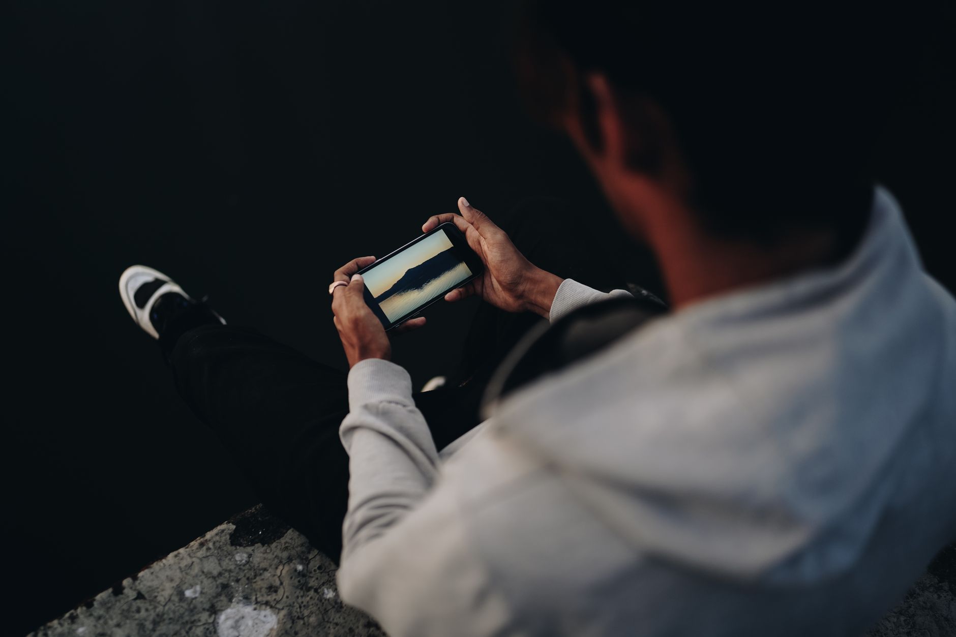 Person scrolling through a social media feed on a smartphone