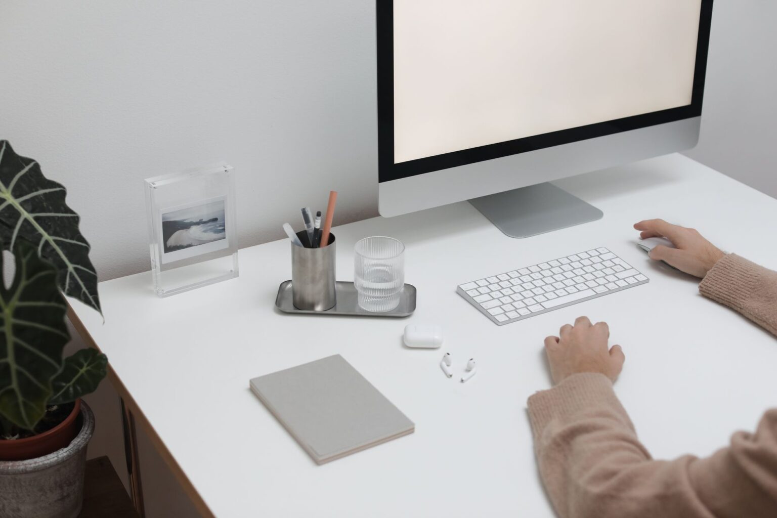 A person working on a Notion database on a laptop at a desk