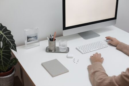 A person working on a Notion database on a laptop at a desk
