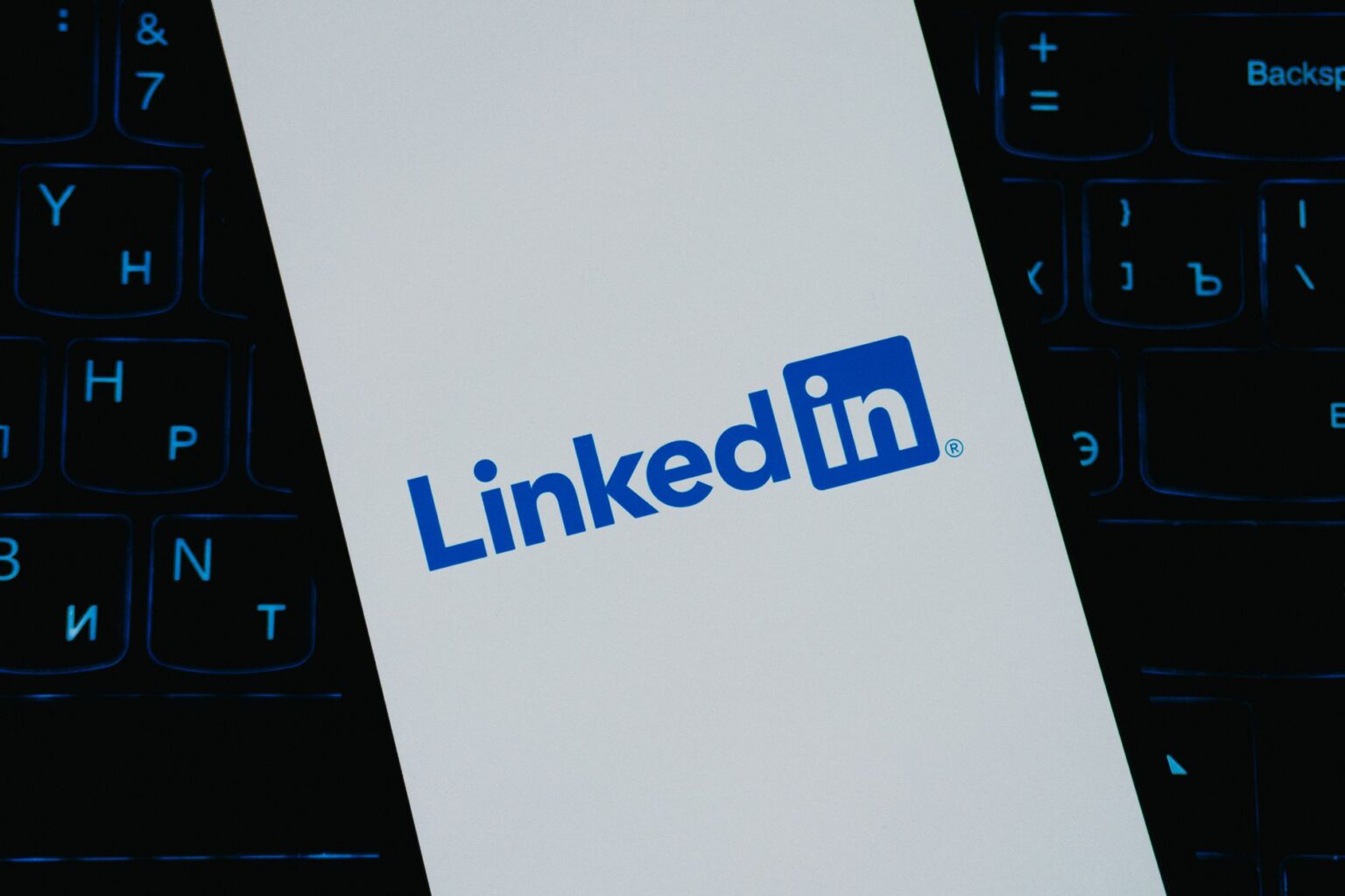 Person scrolling LinkedIn on a smartphone showing video content in the feed