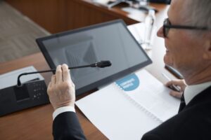 Professional reviewing a business presentation on a laptop screen