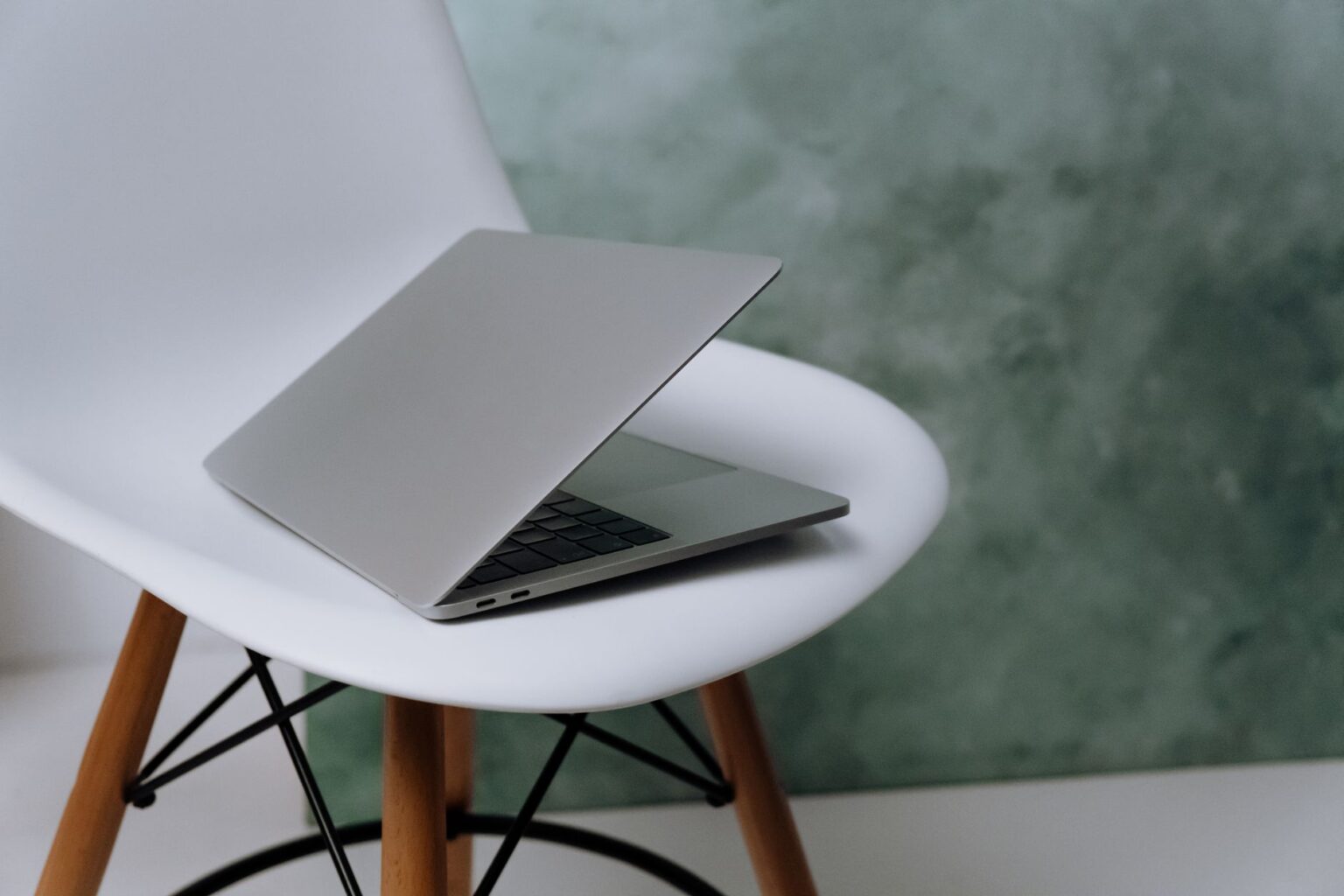 A minimal desk setup with a laptop open to a clean web page