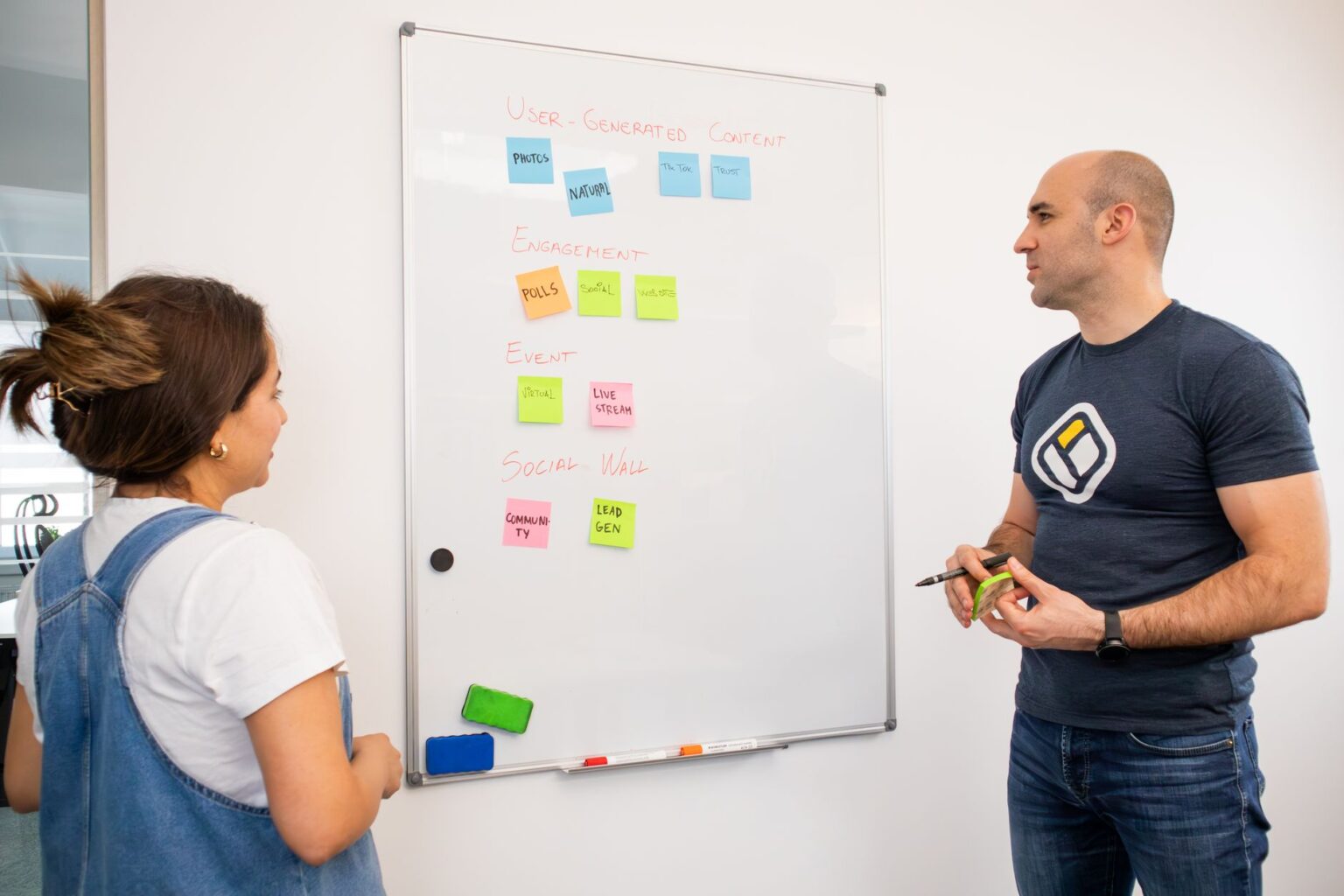 Marketing team reviewing meeting notes on a laptop in a modern office setting