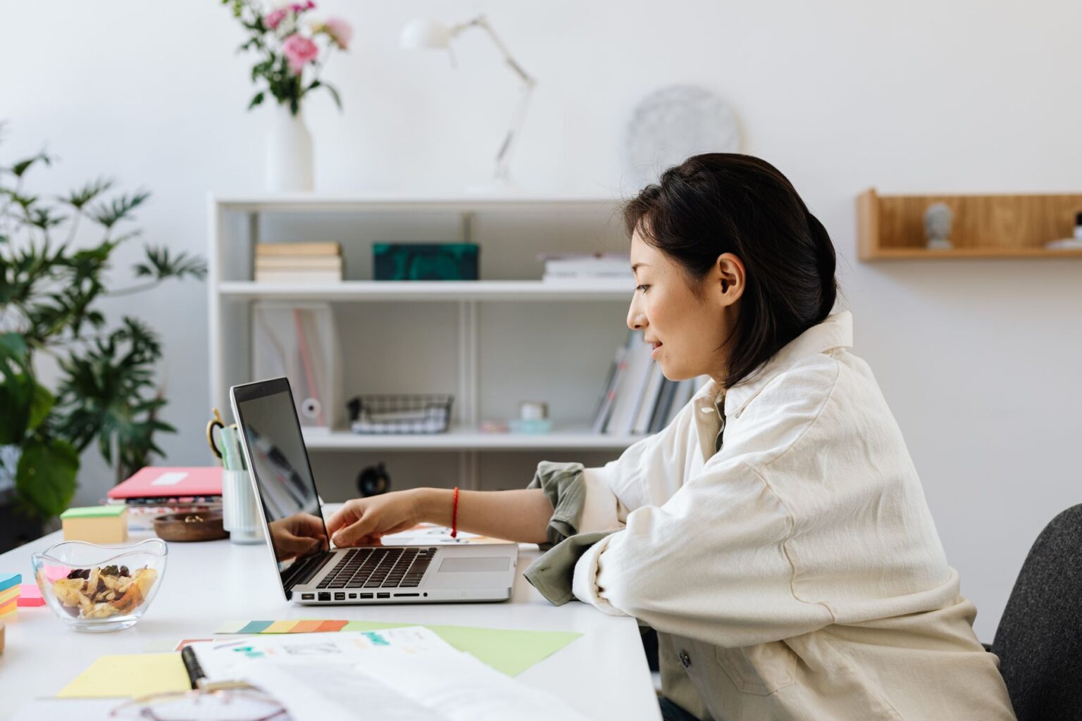 A clean modern workspace with a laptop displaying a digital form interface
