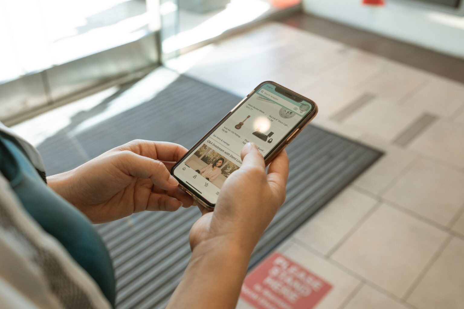 Person browsing a mobile shopping interface on a smartphone