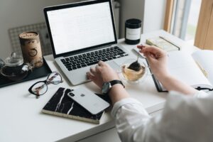 A laptop open to an email newsletter dashboard on a clean desk workspace