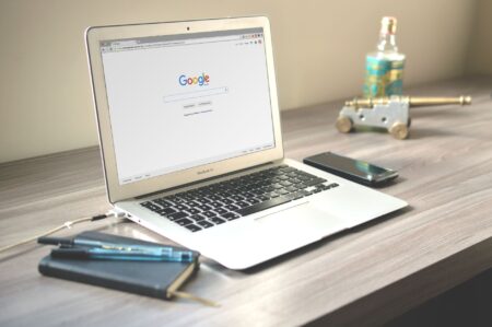 Person browsing the web and saving articles using a browser extension on a laptop