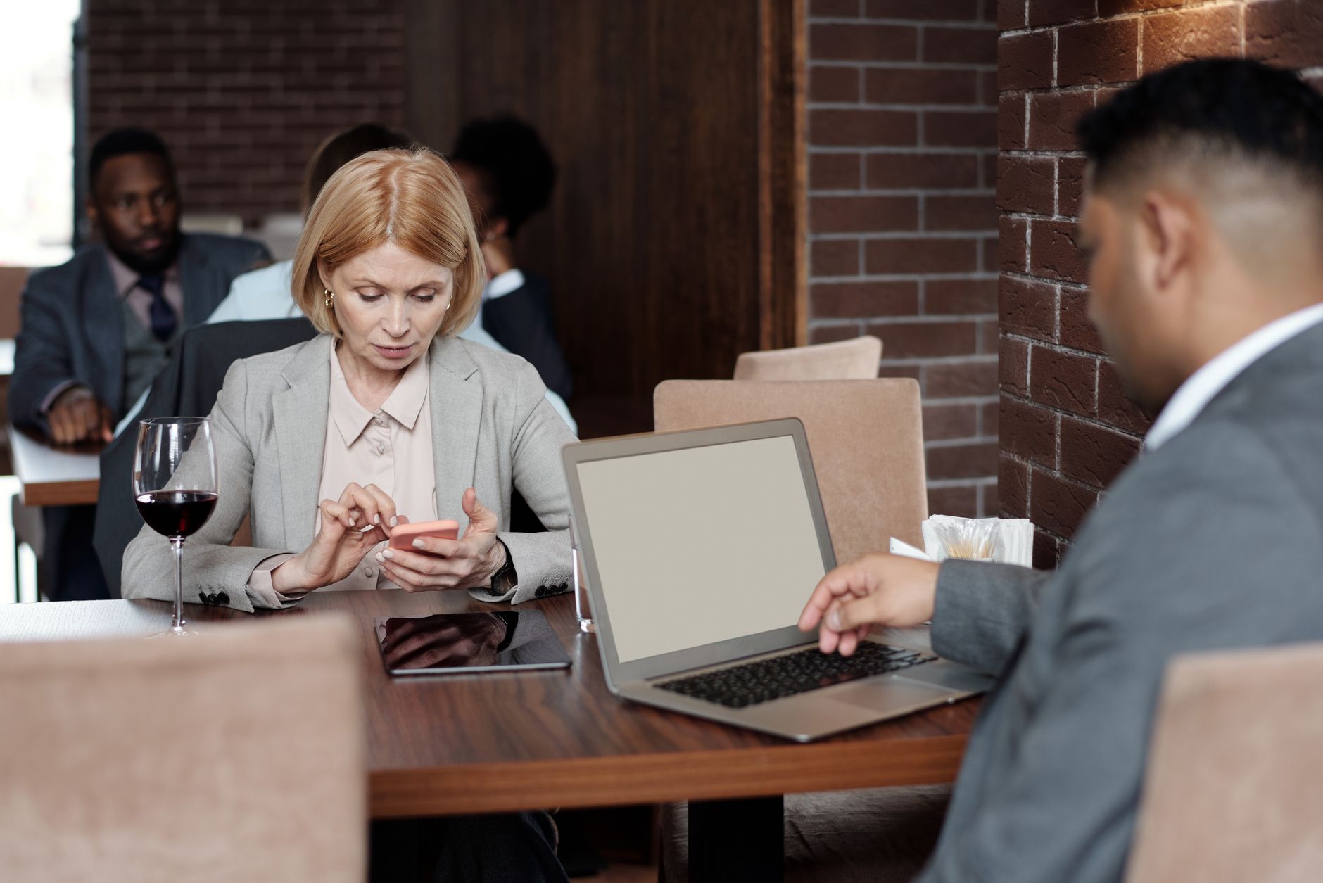 Group of people connecting through digital devices at a table