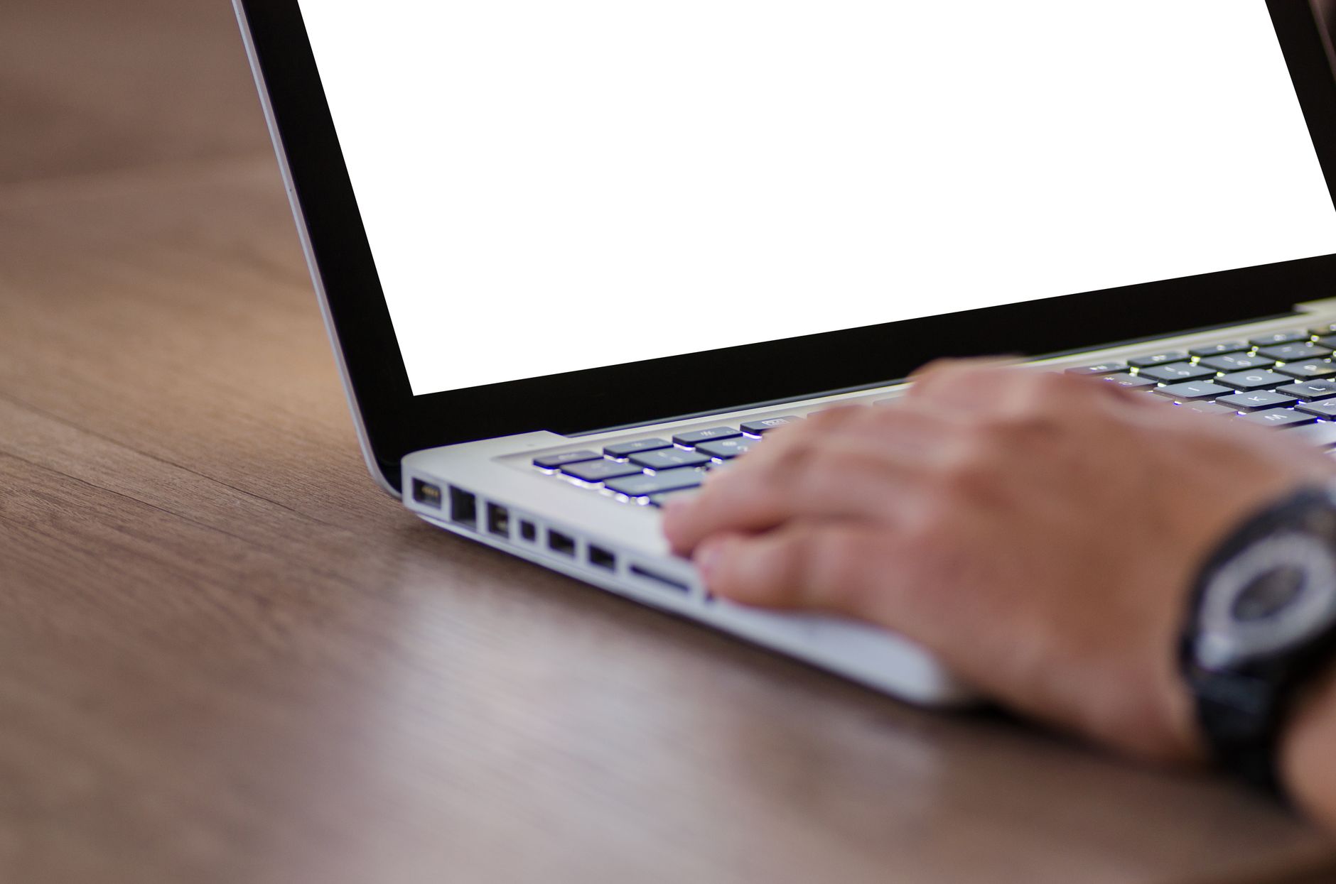 Close-up of hands typing on a laptop, representing AI-assisted content drafting