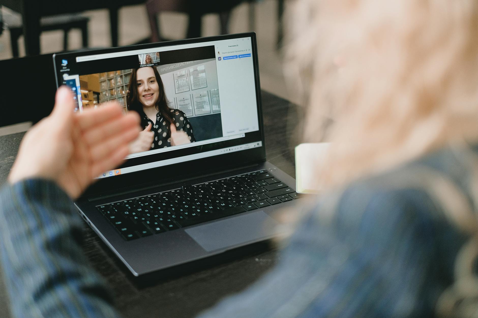 Group of people gathered around a laptop discussing online content
