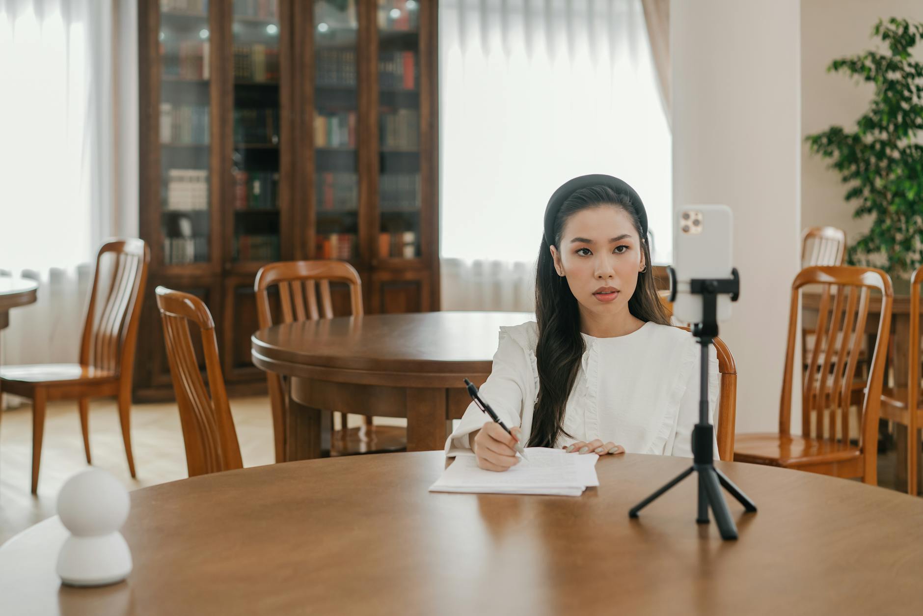 Content creator recording a video with camera equipment in a home studio